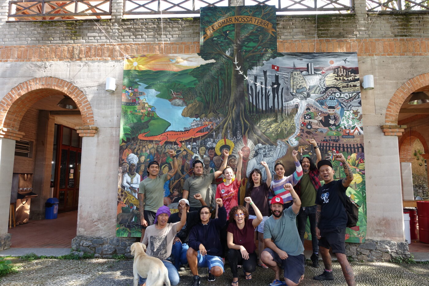 Taring Padi and members of Casa do Povo and MST in front of the artwork they made together during the residency. Image courtesy of Taring Padi.