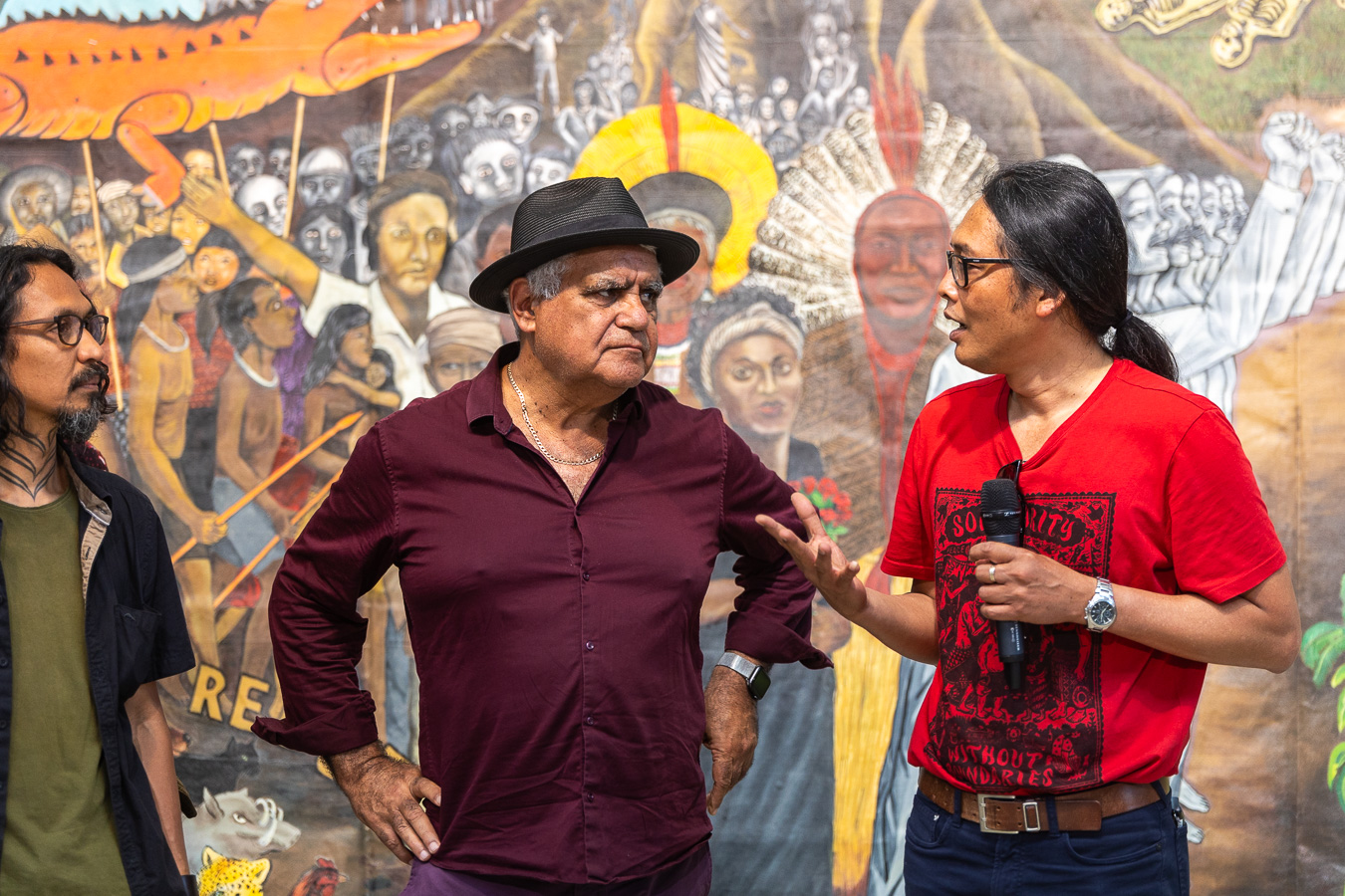 Aboriginal artist and activist Richard Bell speaking with Alex Supartono of the artist collective Taring Padi at the opening of Tanah Merdeka (2023) at Framer Framed in Amsterdam. Photo: Maarten Nauw / Framer Framed